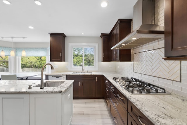 3130 Kayjay Dr, Northbrook, IL 60062 - kitchen with wall chimney range hood, stainless steel gas stovetop, a sink, and tasteful backsplash