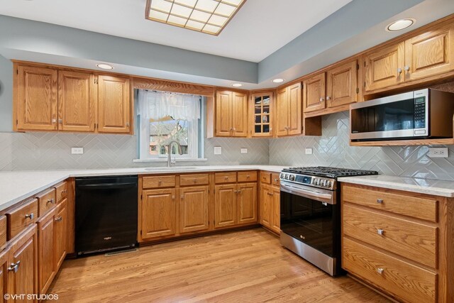 354 Gateshead Dr, Naperville, IL 60565 - kitchen with a sink, light wood-style floors, stainless steel appliances, and brown cabinets