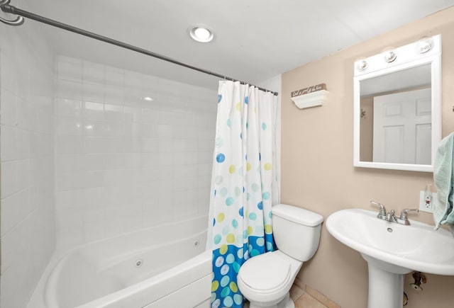 full bath with toilet, shower / bath combo, a sink, and tile patterned floors