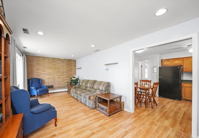 living area featuring light wood finished floors, a baseboard radiator, plenty of natural light, recessed lighting, and ceiling fan