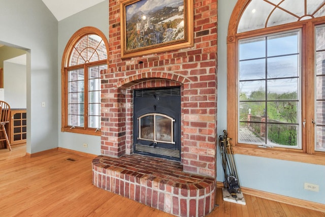 3664 E 2619th Rd, Sheridan, IL 60551 - detailed view of baseboards, wood finished floors, and a brick fireplace