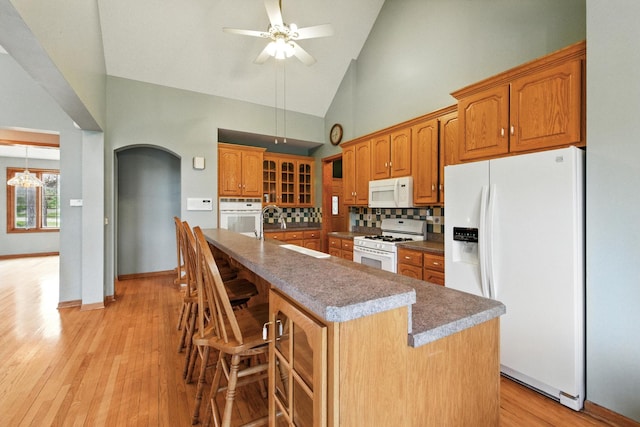 3664 E 2619th Rd, Sheridan, IL 60551 - kitchen with white appliances, a sink, arched walkways, high vaulted ceiling, and ceiling fan