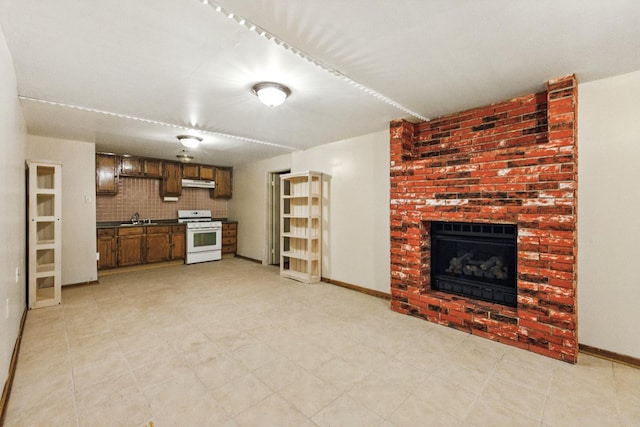 3664 E 2619th Rd, Sheridan, IL 60551 - unfurnished living room with a sink, a fireplace, and baseboards