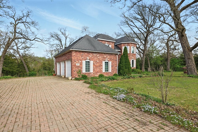 3664 E 2619th Rd, Sheridan, IL 60551 - view of side of property with brick siding, a lawn, decorative driveway, roof with shingles, and an attached garage