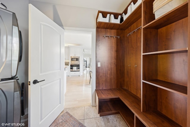 117 Iroquois Dr, Clarendon Hills, IL 60514 - spacious closet featuring stacked washer and clothes dryer and light tile patterned flooring