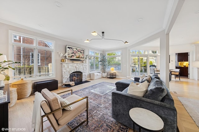 117 Iroquois Dr, Clarendon Hills, IL 60514 - living area with ornamental molding, a stone fireplace, wood finished floors, baseboards, and a chandelier