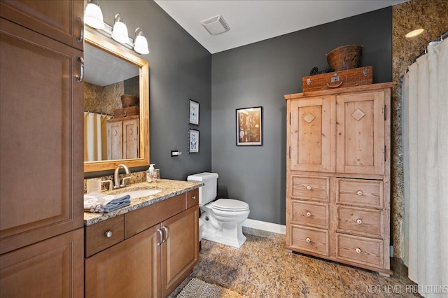 bathroom with toilet, baseboards, visible vents, and vanity
