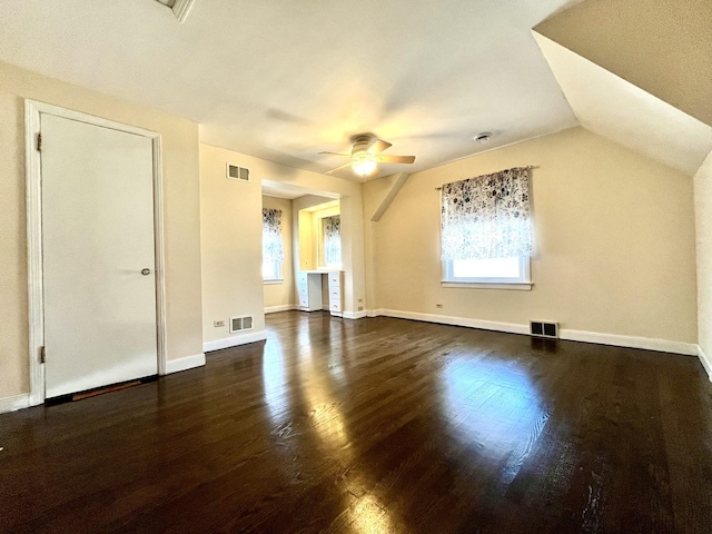 additional living space with visible vents, dark wood-style flooring, ceiling fan, and baseboards