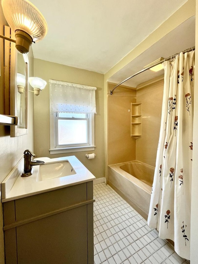 bathroom featuring vanity, baseboards, and shower / bath combo