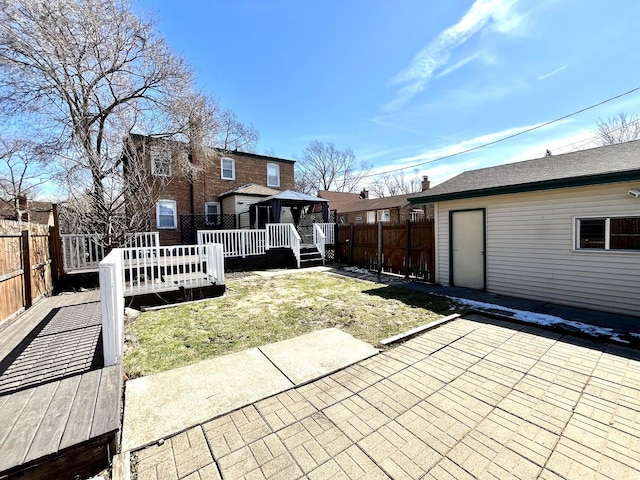 view of patio with a deck, a gazebo, and a fenced backyard