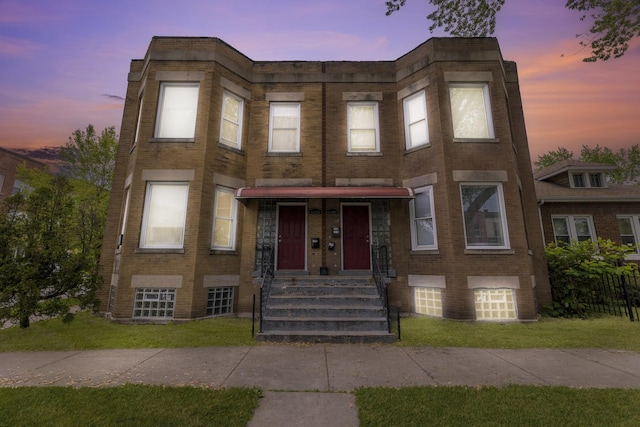 6601 S St Lawrence Ave, Chicago, IL 60637 - townhome / multi-family property with brick siding, an attached garage, and a lawn