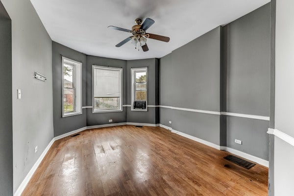 6601 S St Lawrence Ave, Chicago, IL 60637 - empty room featuring wood finished floors, ceiling fan, and baseboards