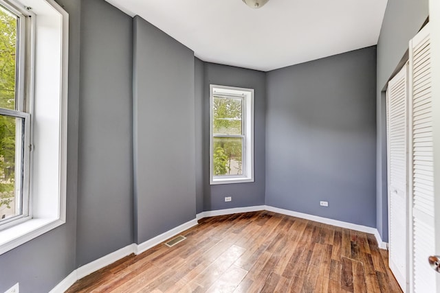 6601 S St Lawrence Ave, Chicago, IL 60637 - spare room featuring wood finished floors and baseboards