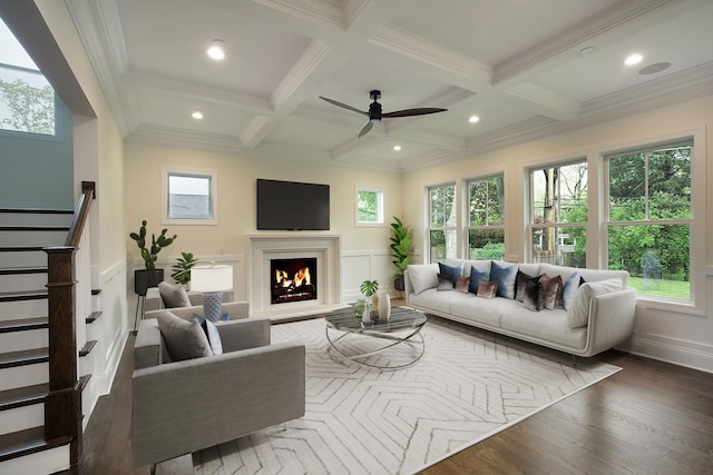 living area featuring beamed ceiling, plenty of natural light, and coffered ceiling