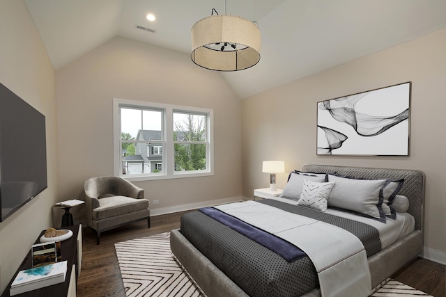 bedroom with baseboards, vaulted ceiling, dark wood-style flooring, and visible vents