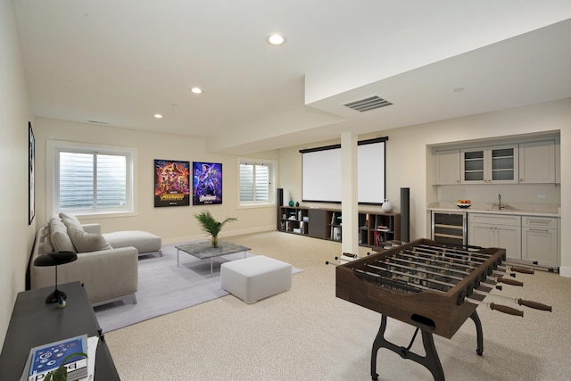 game room featuring visible vents, wine cooler, carpet flooring, indoor wet bar, and a sink
