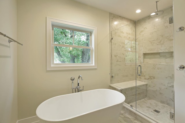 bathroom featuring baseboards, recessed lighting, a freestanding tub, and a stall shower