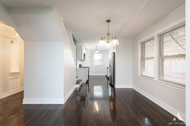 dining space featuring baseboards, an inviting chandelier, and dark wood-type flooring