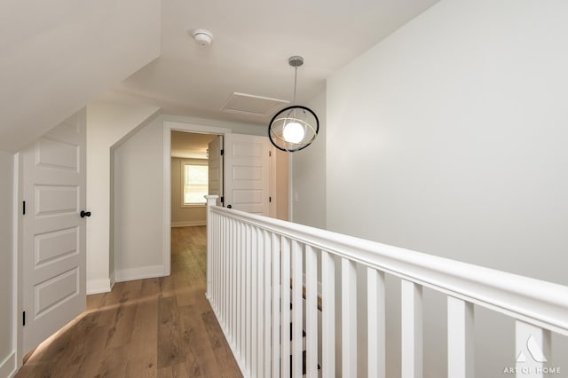 corridor with baseboards and wood finished floors