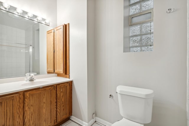 bathroom featuring a shower, toilet, and vanity