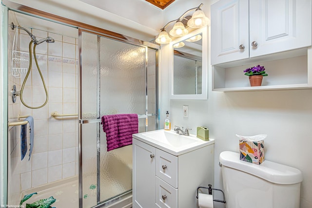 bathroom with vanity, toilet, and a stall shower