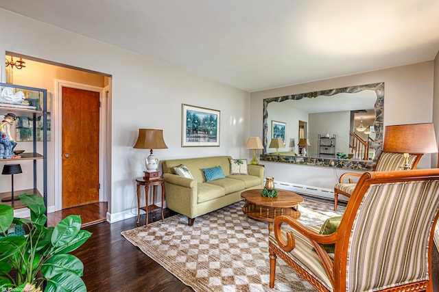 living room featuring baseboards, a baseboard heating unit, and wood finished floors