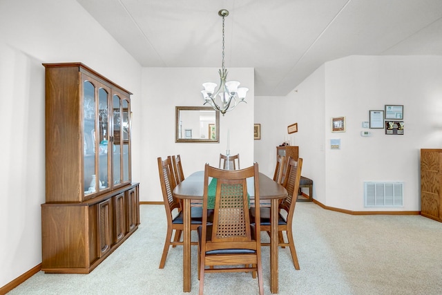 dining space featuring an inviting chandelier, baseboards, light colored carpet, and visible vents