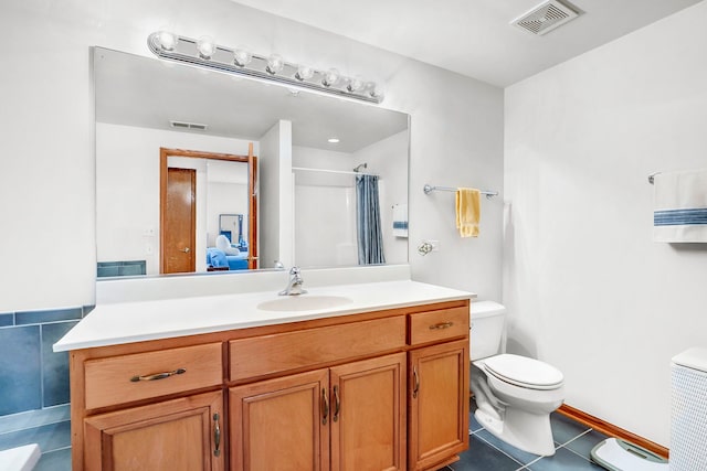 bathroom featuring visible vents, tile patterned floors, toilet, and vanity