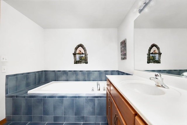 bathroom featuring vanity and a bath