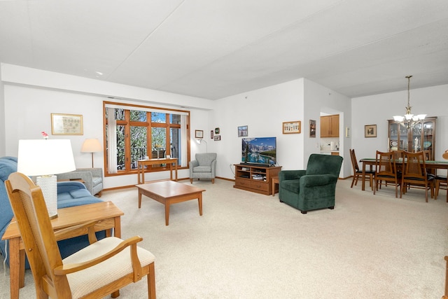 living room with light carpet and a notable chandelier