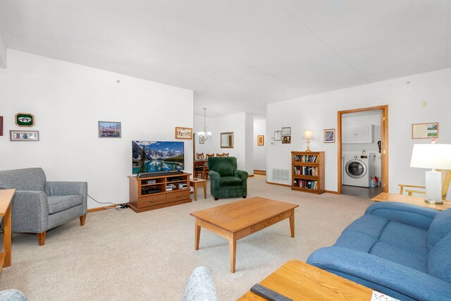 living area with light carpet, a chandelier, baseboards, washer / dryer, and visible vents
