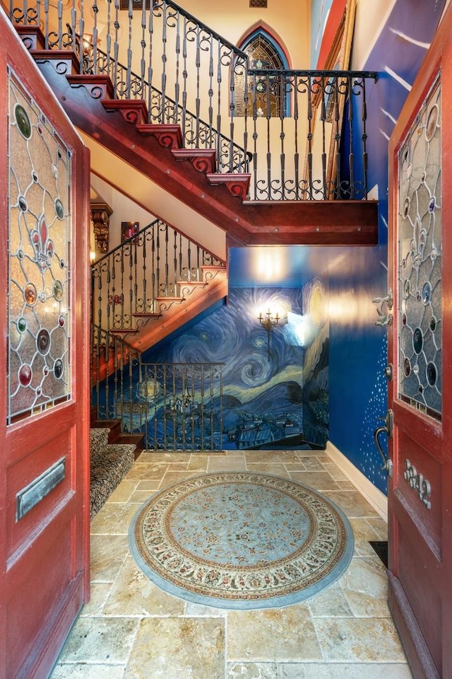 3842 N Alta Vista Ter, Chicago, IL 60613 - foyer with stone tile floors, stairs, baseboards, and a high ceiling