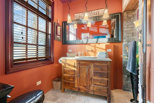 3842 N Alta Vista Ter, Chicago, IL 60613 - bathroom featuring vanity and stone tile flooring