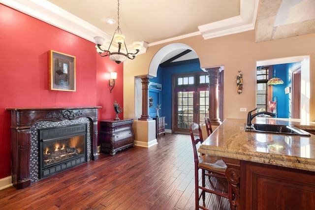 3842 N Alta Vista Ter, Chicago, IL 60613 - dining area featuring arched walkways, a premium fireplace, dark wood-style floors, ornate columns, and crown molding