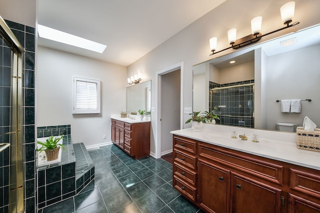 full bathroom with a sink, tile patterned floors, two vanities, a skylight, and a stall shower
