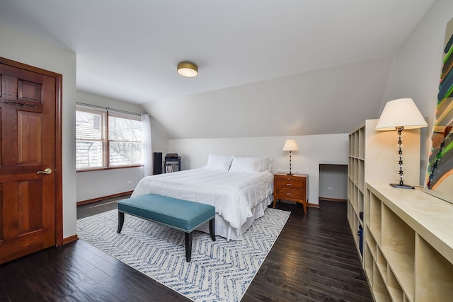bedroom featuring baseboards, dark wood finished floors, and lofted ceiling