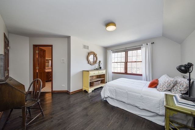 bedroom featuring baseboards, visible vents, dark wood finished floors, and vaulted ceiling