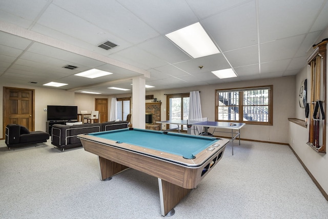 playroom featuring visible vents, light carpet, a brick fireplace, and a paneled ceiling