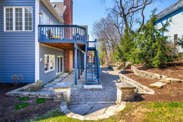 view of yard featuring stairway, a deck, and a patio area