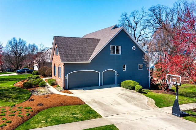 view of side of property featuring roof with shingles, a lawn, and concrete driveway