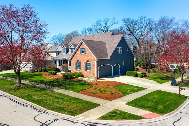 view of front facade featuring a front yard, brick siding, concrete driveway, an attached garage, and a shingled roof