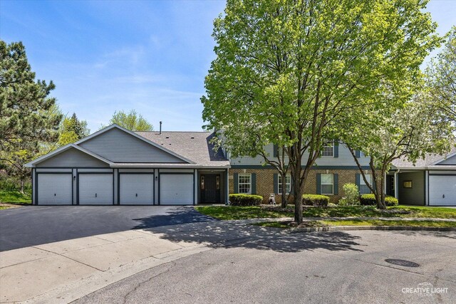 1025 Chaucer Ct E Unit B, Elgin, IL 60120 - multi unit property featuring asphalt driveway, brick siding, an attached garage, and roof with shingles