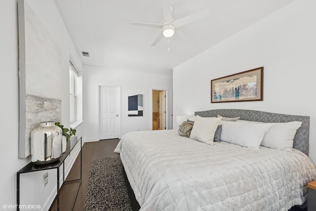 bedroom featuring ceiling fan, visible vents, and dark wood finished floors