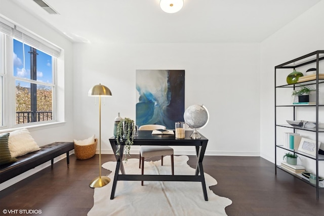 office area with baseboards, wood finished floors, and visible vents