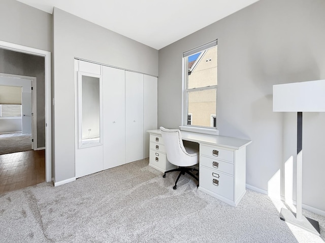 carpeted home office with baseboards