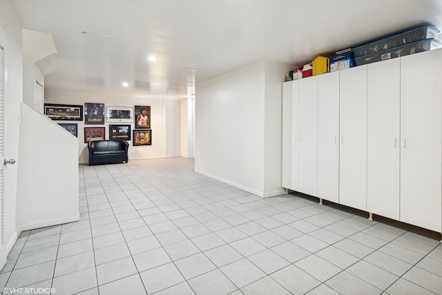 below grade area with recessed lighting, baseboards, and light tile patterned floors