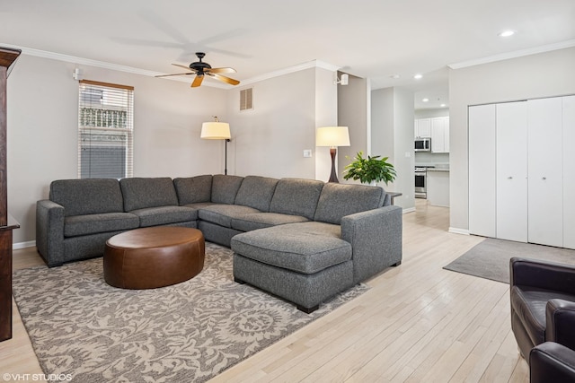 living room featuring visible vents, crown molding, recessed lighting, a ceiling fan, and light wood finished floors