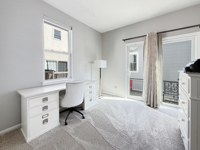 home office featuring baseboards and light carpet