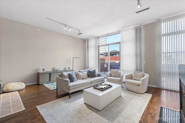 324 N Jefferson St Unit 307, Chicago, IL 60661 - living area featuring rail lighting, wood finished floors, a wall of windows, and baseboards