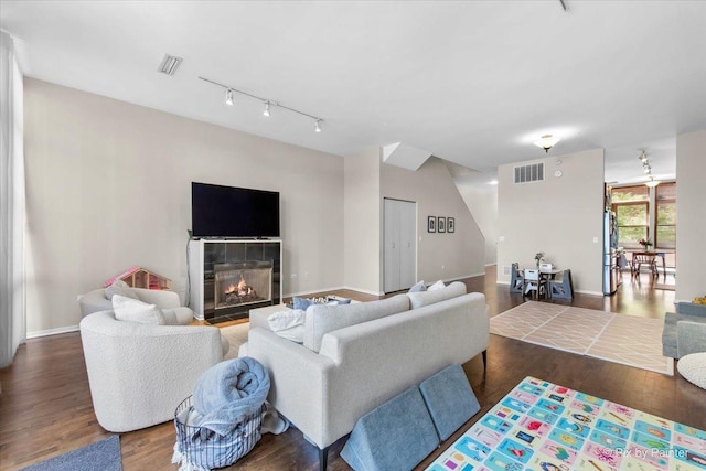324 N Jefferson St Unit 307, Chicago, IL 60661 - living room with track lighting, wood finished floors, a tiled fireplace, and baseboards